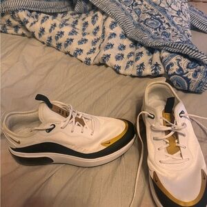 White and gold Nike sneakers